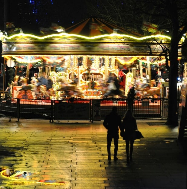 A vibrant night market scene during a cultural festival, with diverse food stalls, glowing lanterns, and happy crowds enjoying the atmosphere.