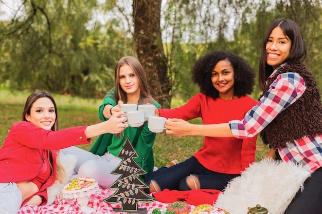 A diverse group of people participating in a Juneteenth picnic in a park, sharing food and laughter under the shade of trees. Red, black, and green blankets are spread on the grass.