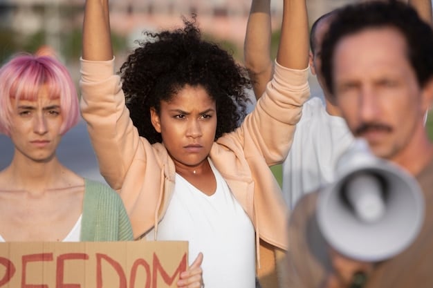 A group of young activists holding banners during a Juneteenth rally, advocating for racial justice and voting rights. The sun is shining, and the mood is determined.
