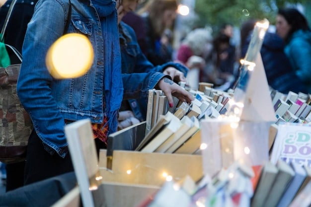 A bustling book market within a literary festival, with diverse attendees browsing various titles and engaging with booksellers.