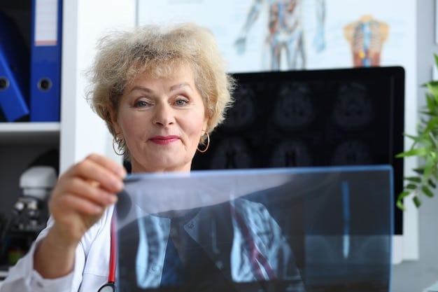 A healthcare professional explaining bone density scan results on a computer screen to a middle-aged woman, highlighting the importance of understanding and managing bone health.