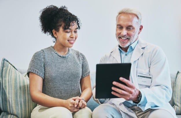 A doctor in a pristine white coat, smiling and conversing with a patient on a tablet screen, symbolizing the human connection often maintained during telehealth consultations.