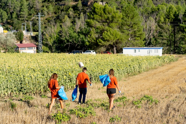 A group of enthusiastic local farmers in a rural setting, demonstrating modern irrigation techniques in a lush field, signifying agricultural development driven by foreign aid.