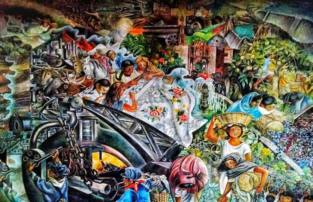 A detailed, vibrant street art mural depicting diverse cultural symbols and faces, serving as a backdrop for a bustling outdoor market with artisans selling handcrafted goods.