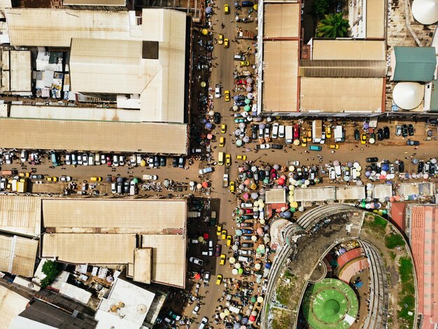 An aerial view of a revitalized historic downtown area, bustling with tourists and local businesses, demonstrating successful cultural preservation driving economic development.