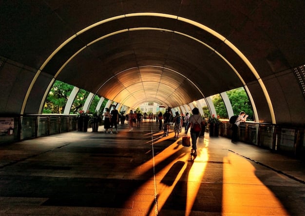 A modern performing arts center illuminated at night in an urban setting, with diverse people walking by, symbolizing the architectural and community impact of cultural infrastructure.