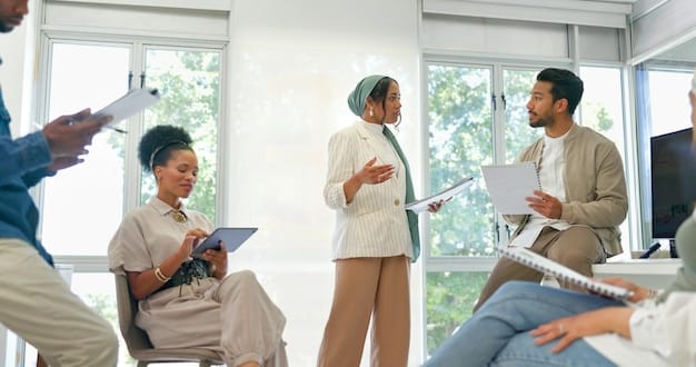 A diverse group of four professionals in a modern office setting, discussing wellness program pamphlets. One person is in a wheelchair and is actively engaged in the conversation, illustrating inclusivity.