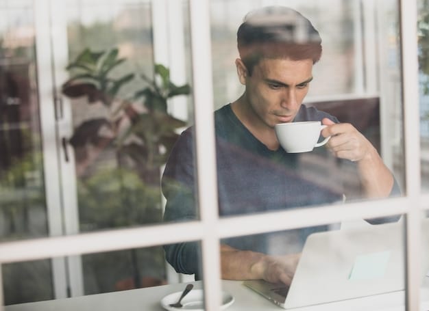 A person taking a mindful coffee break, away from their computer, looking out a window, symbolizing healthy disengagement.