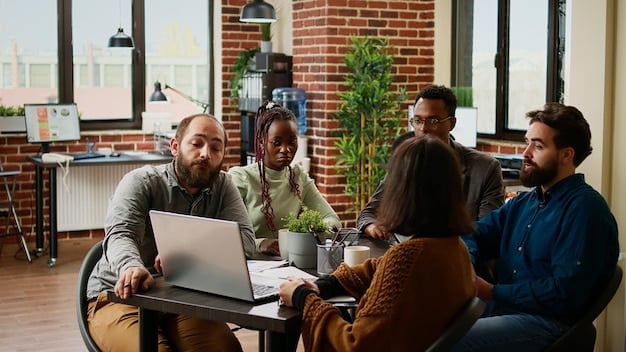A diverse group of employees laughing and interacting in a modern, open-plan office space, some working on laptops, others in casual conversation, symbolizing a positive and flexible work environment.