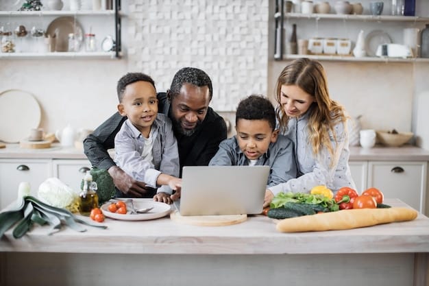 A family, including children, sitting around a kitchen table, looking at a laptop and smiling, suggesting successful health insurance enrollment.