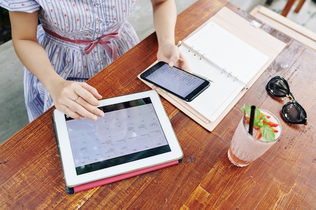 A student efficiently managing their digital calendar on a tablet, with various color-coded academic and personal appointments, demonstrating organized scheduling.