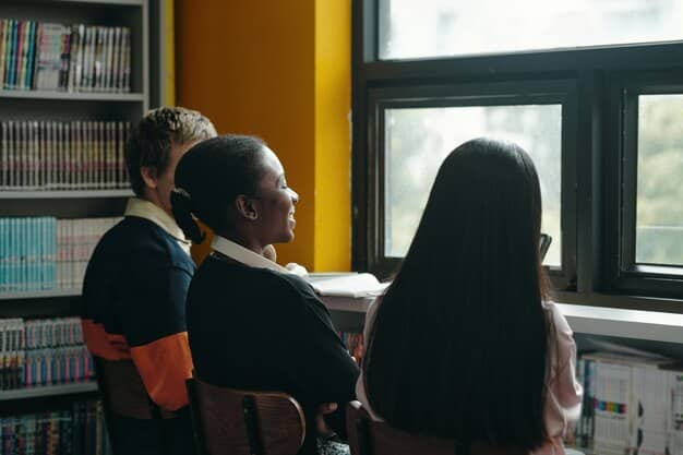 A student and a mentor engaged in a focused discussion in a university library, surrounded by books, implying intellectual growth and personal connection. The mentor is gesturing, explaining a concept, and the student is actively listening and taking notes.