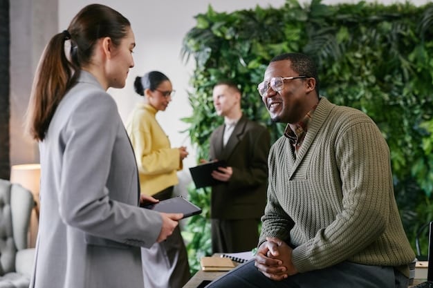 A mentor and mentee attending a professional networking event, smiling and engaging with other attendees, showing active participation and expansion of their professional circle.